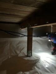 Finished encapsulation with SilverGlo along the foundation walls and CleanSpace installed overtop each footing, below each wooden post