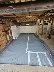 Drainage matting was installed beneath the new concrete floor to manage moisture and provide an additional protective layer.