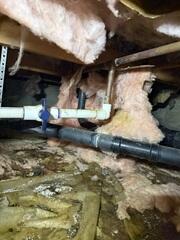 Water accumulates in the crawl space, soaking up through the fiberglass insulation