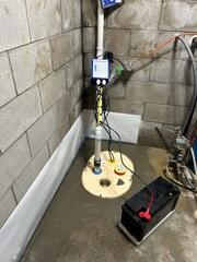 The crew installs the TripleSafe sump pump system to drain water out of the basement: keeping it dry for good!