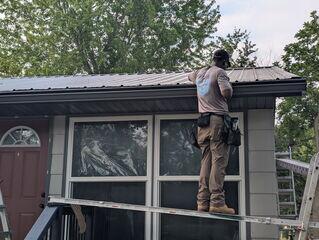 Working on getting the new Gutter Shutter System installed at the proper location to the roof line.