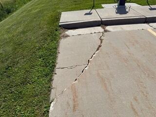 Osage, IA, Sinking Front Walkway and Parking Lot Repaired