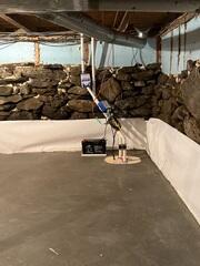 CleanSpace® Wall System - Installed along the lower portion of the stone foundation walls to manage wall moisture and direct it downward into the basement drainage system. TripleSafe® Sump Pump System - Provides three levels of sump pump protection, including primary pumping capacity, additional pumping protection during high-water conditions, and battery-backup protection during power outages. SmartJack® XT Support System - Heavy-duty, adjustable steel supports used to replace inadequate basement columns and provide dependable support for the beams and floor structure above.