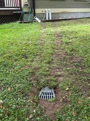 LawnScape™ Outlet provides a discreet termination point for the buried sump discharge line and releases pumped water away from the home's foundation.
