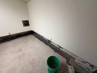 The crew installs the subfloor drainage system.