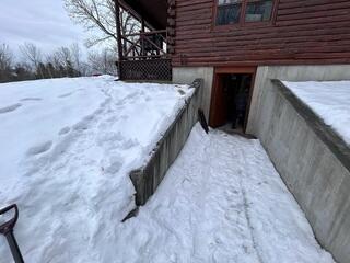 The walkout basement retaining wall in Albany, Vermont, needed repair to ensure the homeowners' safety.