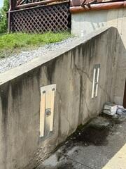GeoLock® Wall Anchor System - A foundation wall stabilization system that uses heavy-duty earth anchors, galvanized steel connecting rods, and steel wall plates to secure a compromised wall to stable soil. The system provides permanent stabilization without requiring complete wall replacement.