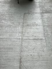 Cracks in the  back porch floor due to a shifting foundation.