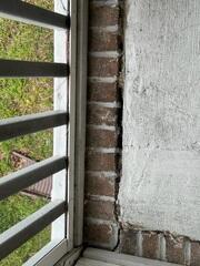 Cracks in the front porch floor due to a shifting foundation.