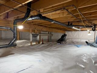 CleanSpace® Crawl Space Encapsulation System - A durable liner designed to isolate the crawl space from ground moisture while providing a clean, bright, and easier-to-maintain environment beneath the home.