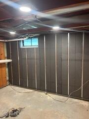 Basement-to-Beautiful® Wall System - A basement wall pre-finishing system combining continuous R-13 SilverGlo graphite-infused rigid foam insulation with integrated steel framing. The 2½-inch panels include built-in wiring channels and provide attachment points for future wall finishes, eliminating the need for conventional wood framing and fiberglass insulation.