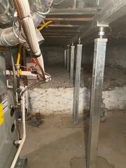 With the SmartJack XT system in place, the steel beams take on some of the weight from the old floor joists, stabilizing the foundation and allowing the sinking floors to be corrected.