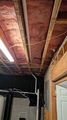 Pipe continues recessed in the rafters so that the homeowner can easily drywall over it in the future.
