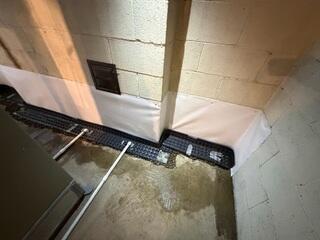 Our crew was able to install the WaterGuard drainage system around the basement perimeter, integrating the condensate lines with the system.