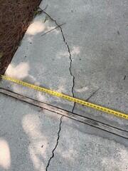 Measuring the unlevel pieces of concrete in the middle of an expansion point. A design specialist conducted a free inspection and provided the home owner with a estimate for solutions.