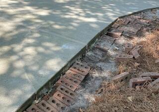 The repaired cracks in the concrete driveway with PolyLevel and NexusPro Crack Repair.