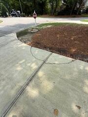 The unlevel pieces of concrete in the middle of an expansion point of the driveway.