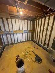 During: Our crew worked hard to secure all the waterproofing products throughout the basement.