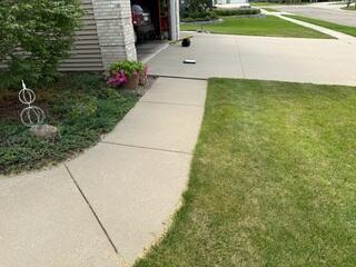 Before: Our Design Specialist, Nathan, recommended lifting the damaged walkway and driveway.
