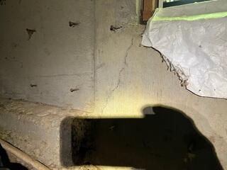 Ground water had damaged this foundation wall, leading to the formation of cracks, leaving the weight of the home not properly supported.