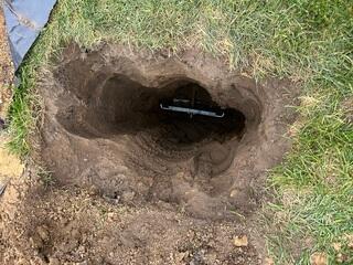 The earth anchor is placed inside the hole that was created and connected to the interior wall plate.