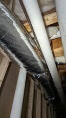 Here, the radon pipe continues along the same path as existing ductwork.