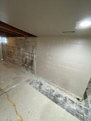 Before: Our Design Specialist, AJ, recommended securing several waterproofing products throughout the basement.