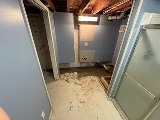 The crew removed a vertical section of drywall to seal the leaky wall crack behind it.