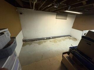 The crew digs a trench around the basement perimeter to install the subfloor waterproofing system.