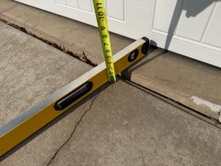 The driveway where it had settled against the garage