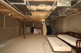 This Holmdel, NJ basement started as a completely unfinished blank slate with block foundation walls, exposed insulation between the ceiling joists, and unfinished flooring. Before finishing the space, our team evaluated the existing conditions and identified an area where a previous leak had occurred.