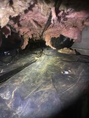 Fiberglass is made to exist within a six-sided box, once moisture absorbs into it, it droops, negating its insulation value