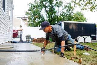 With the old, settled concrete removed and the SunHouse installed, the team replaced the entire sidewalk and walkway with brand-new concrete. The completed surface gives the Edison home a completely refreshed walkway where the previous slabs had settled one to two inches.