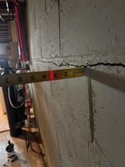 A close-up of the cracked block foundation where our Jackson was measuring how much it had bowed.