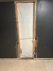 The crew finished the crack repair by covering it with our CleanSpace wall vapor barrier. The next day, our wall restoration crew repaired the drywall.