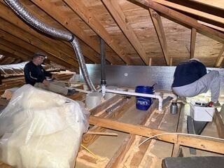 Crew airsealing and installing can light covers.