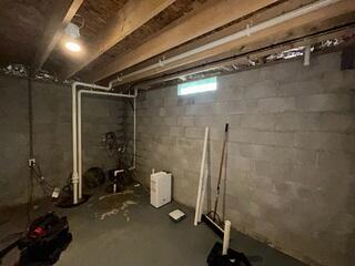 The basement during inspection. The walls were leaking and the sump pump was in need of an upgrade.