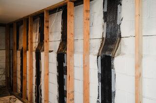 Our team installed CarbonArmor carbon fiber reinforcement to provide additional support to the affected block foundation walls. The system is designed to help resist further inward movement while maintaining a relatively low profile.