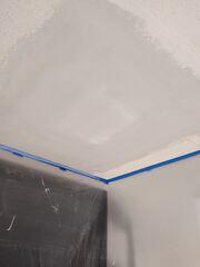 Ceiling repair in progress after the damaged areas were patched and prepared for new popcorn texture.