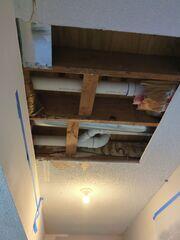 Garage protected with plastic containment while the ceiling drywall repair and popcorn texture work were underway.