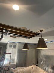 Work area protected with plastic containment while the ceiling repair is underway.
