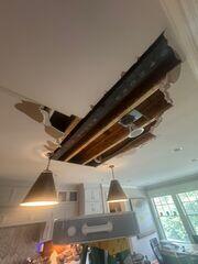Wide view of the large open ceiling section with framing and other components exposed.