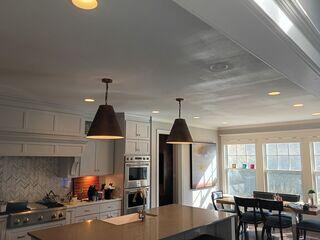 Wide finished view showing the restored ceiling across the kitchen.