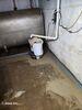 Wet Basement Repaired with Sump Pump Installation in Marinette, WI - Photo 1