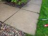 Concrete Garage Apron & Sidewalk Leveled & Repaired with PolyLevel Injection Foam and NexusPro Joint Sealant in Menasha, WI - Photo 1