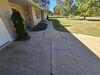 Severely Damaged Concrete Driveway and Walkway Lifted and Cracks Sealed in Schofield, Wisconsin - Photo 2