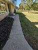 Severely Damaged Concrete Driveway and Walkway Lifted and Cracks Sealed in Schofield, Wisconsin - Photo 3