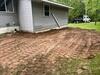 Sloped & Settled Home Addition Saved with Foundation Pier System Installation in Menominee, MI - Photo 1