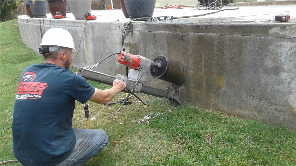 Commercial Foundations Helical Piering on Retaining Wall in Orange
