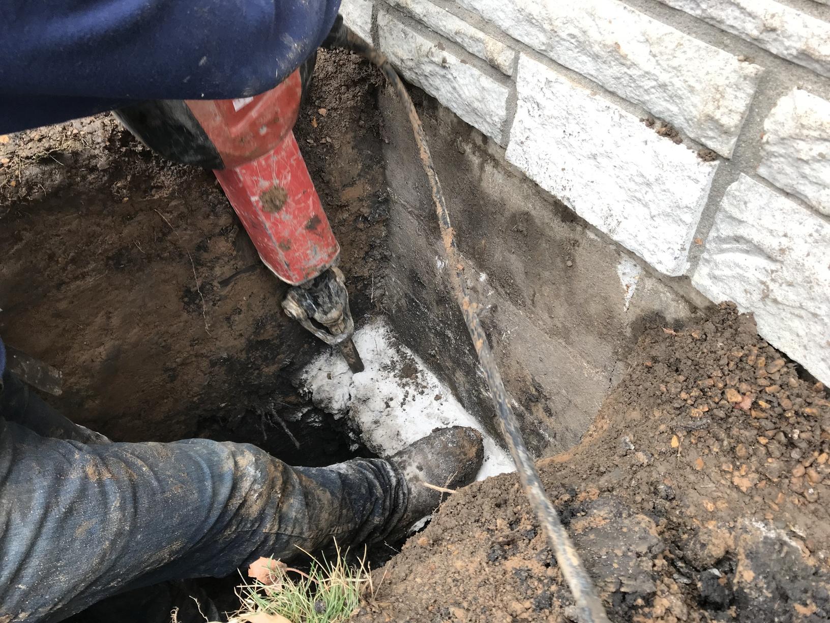 Foundation Repair Outside Foundation Piering Installation Steps Step Two Notch the footing.